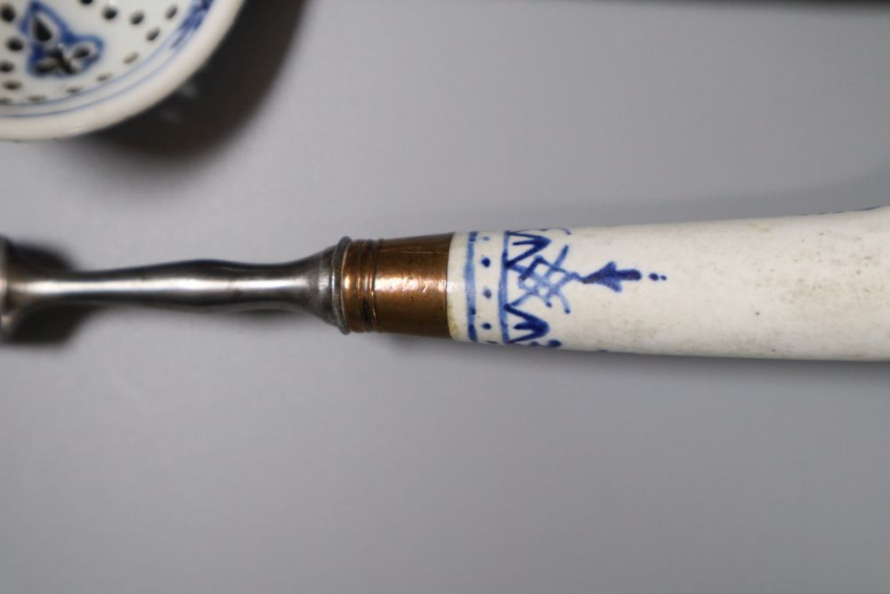 A Bow pistol grip blue and white handled fork, c.1770, 23cm, and a Continental porcelain blue and white strainer ladle, 17cm